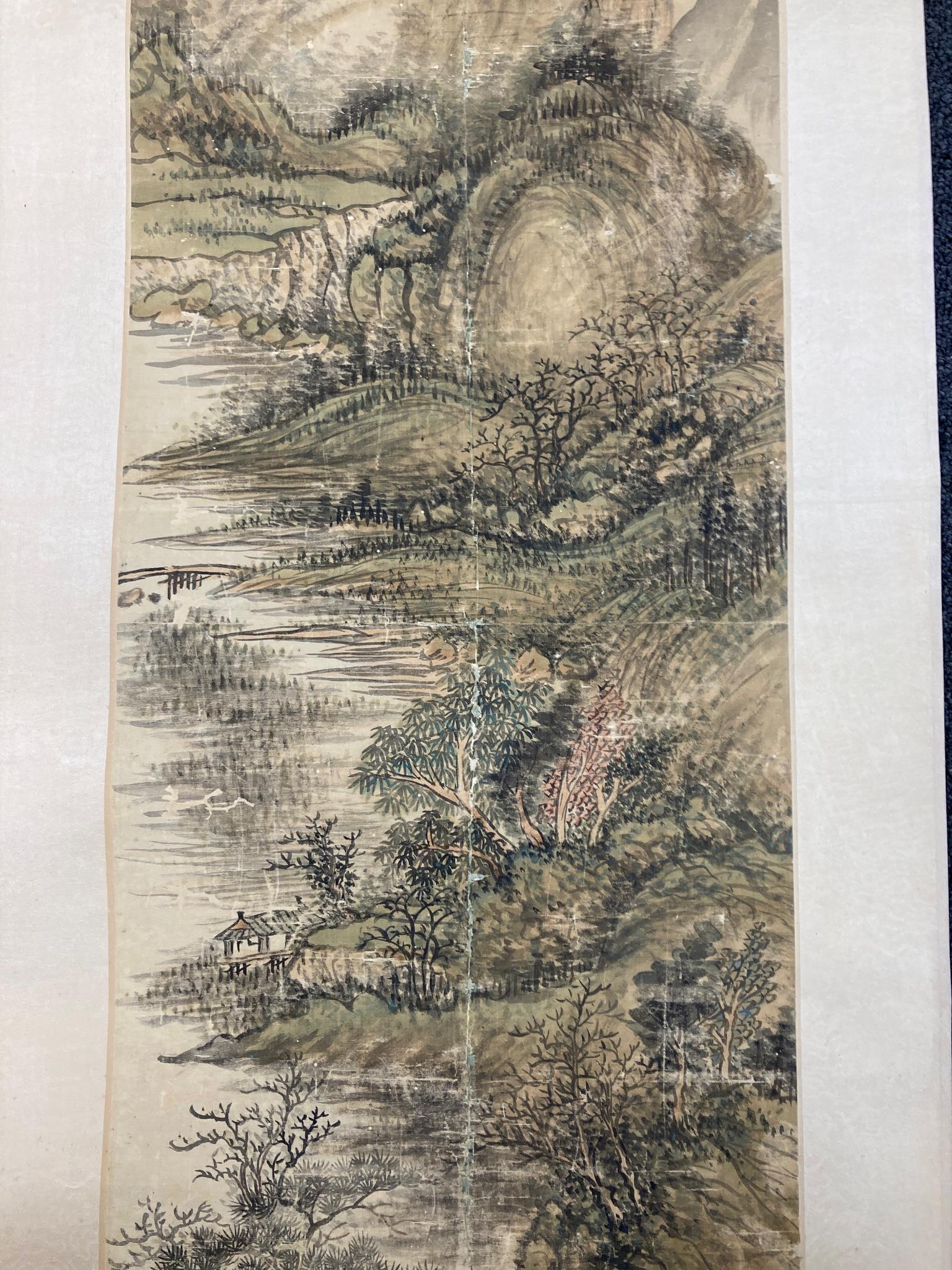 A Chinese landscape scroll painting on silk, Qing dynasty inscribed and signed, artist’s seal and collector’s seal lower left, image 139cm x 27.5cm, remounted